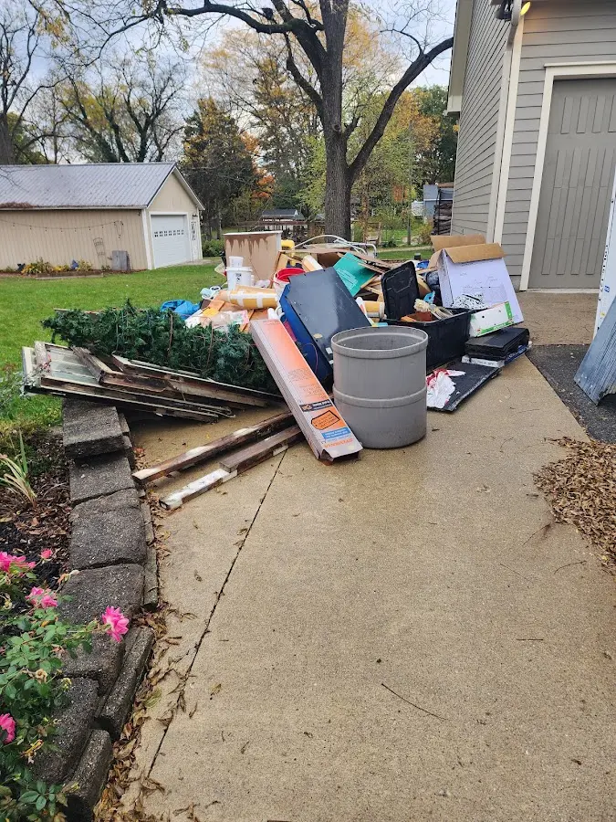Dumpster being loaded with debris for 12 Yard Dumpster Rental in Downey